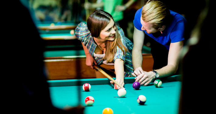 loving couple playing billiards